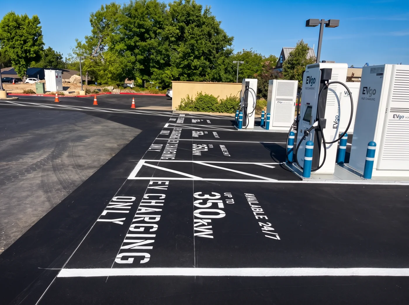 Close view of asphalt parking stalls beside EV chargers