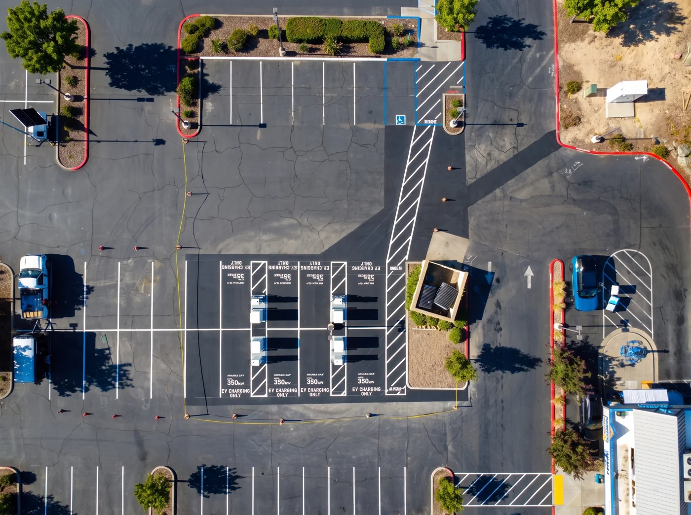 Overhead view of parking aisles and paved charging area